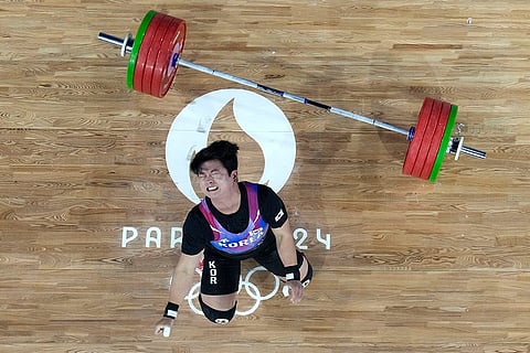 Bak Joo-hyo of South Korea reacts during men's 73kg weightlifting event